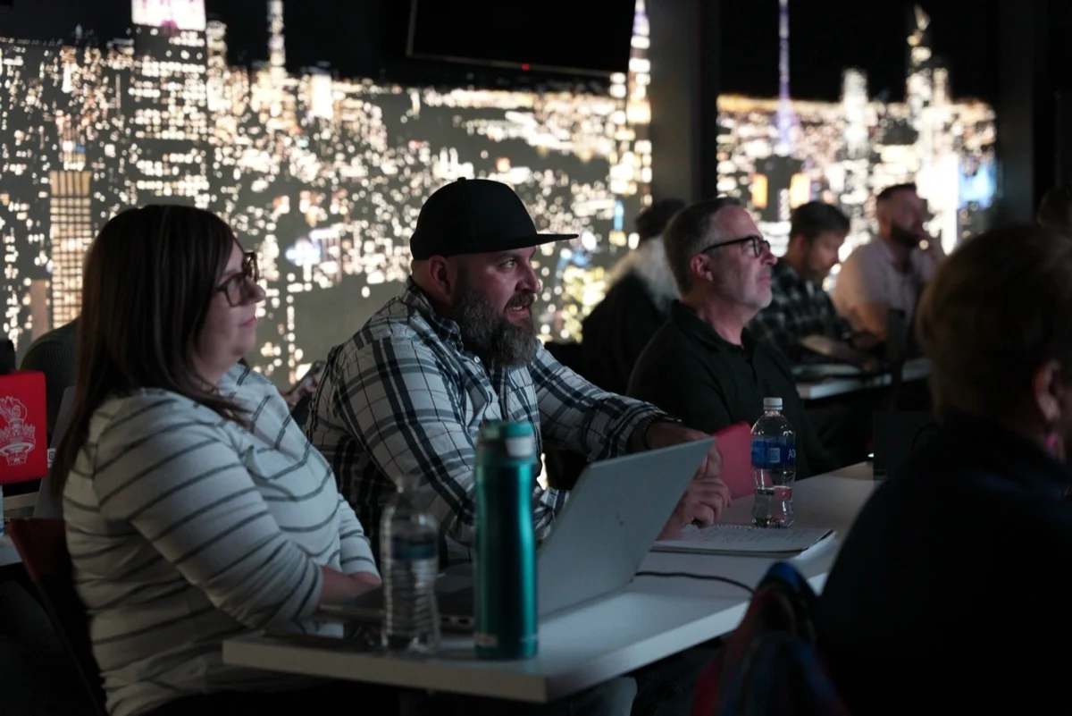 Attendees taking notes during a studio workshop